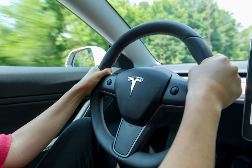 a person driving the Tesla Model 3
